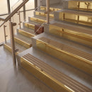 Polished Brass finish with Fawn Castellated insert - 59.5mm solid brass raked front single channel stair nosing fitted to a stone step