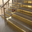 Polished Brass finish with Granite Castellated insert - 59.5mm solid brass raked front single channel stair nosing fitted to a stone step