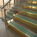 Polished Brass finish with Jade Castellated insert - 59.5mm solid brass raked front single channel stair nosing fitted to a stone step