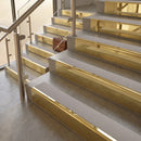 Polished Brass finish with Light Grey Smooth Textured insert - 59.5mm solid brass raked front single channel stair nosing fitted to a stone step