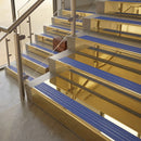 Polished Brass finish with Mid Blue Castellated insert - 59.5mm solid brass raked front single channel stair nosing fitted to a stone step