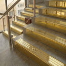 Polished Brass finish with Polished Brass insert - 59.5mm solid brass raked front single channel stair nosing fitted to a stone step