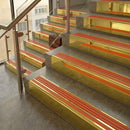 Polished Brass finish with Poppy Castellated insert - 59.5mm solid brass raked front single channel stair nosing fitted to a stone step
