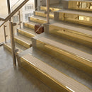 Polished Brass finish with Porth Stone Castellated insert - 59.5mm solid brass raked front single channel stair nosing fitted to a stone step