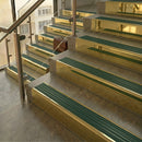 Polished Brass finish with Spruce Castellated insert - 59.5mm solid brass raked front single channel stair nosing fitted to a stone step