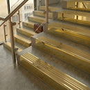 Polished Brass finish with Satin Brass insert - 59.5mm solid brass raked front single channel stair nosing fitted to a stone step
