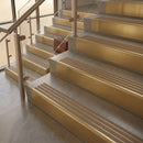 Satin Brass finish with Fawn Castellated insert - 59.5mm solid brass raked front single channel stair nosing fitted to a stone step