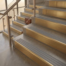 Satin Brass finish with Flint Castellated insert - 59.5mm solid brass raked front single channel stair nosing fitted to a stone step