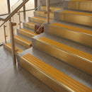 Satin Brass finish with Gold Castellated insert - 59.5mm solid brass raked front single channel stair nosing fitted to a stone step