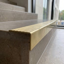 Solid Brass Stair Nosing 59.5mm Tread Raked Front Single Channel in polished brass finish fitted on a step edge