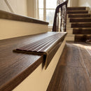 Solid brass stair nosing 59mm raked back slimline in antique brass finish with claret castellated anti-slip insert, fitted to a stair tread
