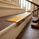 Solid brass stair nosing 59mm raked back slimline in antique brass finish with gold castellated anti-slip insert, fitted to a stair tread