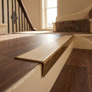 Solid brass stair nosing 59mm raked back slimline in antique brass finish with ivory castellated anti-slip insert, fitted to a stair tread