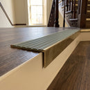 Solid brass stair nosing 59mm raked back slimline in antique brass finish with jade castellated anti-slip insert, fitted to a stair tread