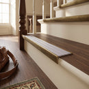 Solid brass stair nosing 59mm raked back slimline in antique brass finish with nimbus castellated anti-slip insert, fitted to a stair tread
