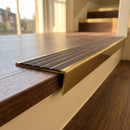 Solid brass stair nosing 59mm raked back slimline in antique brass finish with peat castellated anti-slip insert, fitted to a stair tread