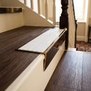 Solid brass stair nosing 59mm raked back slimline in antique brass finish with polar grey castellated anti-slip insert, fitted to a stair tread