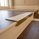 Solid brass stair nosing 59mm raked back slimline in antique brass finish with porth stone smooth textured anti-slip insert, fitted to a stair tread