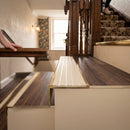 Solid brass stair nosing 59mm raked back slimline in antique brass finish with porth stone castellated anti-slip insert, fitted to a stair tread