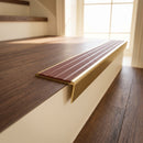 Solid brass stair nosing 59mm raked back slimline in antique brass finish with rustic castellated anti-slip insert, fitted to a stair tread