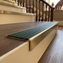 Solid brass stair nosing 59mm raked back slimline in antique brass finish with spruce castellated anti-slip insert, fitted to a stair tread