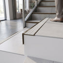 Solid brass stair nosing 59mm raked back slimline in antique bronze finish with light grey castellated anti-slip insert, fitted to a stair tread