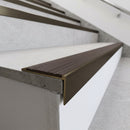 Solid brass stair nosing 59mm raked back slimline in antique bronze finish with peat castellated anti-slip insert, fitted to a stair tread