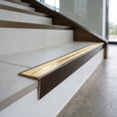 Solid brass stair nosing 59mm raked back slimline in antique bronze finish with polished brass anti-slip insert, fitted to a stair tread