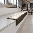 Solid brass stair nosing 59mm raked back slimline in antique bronze finish with porth stone smooth textured anti-slip insert, fitted to a stair tread