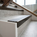 Solid brass stair nosing 59mm raked back slimline in antique bronze finish with regency castellated anti-slip insert, fitted to a stair tread