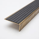 Solid brass stair nosing 59mm raked back slimline profile in antique bronze finish with black castellated insert, studio view