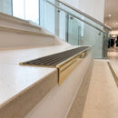 Solid brass stair nosing 59mm raked back slimline in polished brass finish with antique brass anti-slip insert, fitted to a stair tread