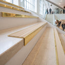 Solid brass stair nosing 59mm raked back slimline in polished brass finish with ivory castellated anti-slip insert, fitted to a stair tread