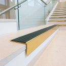 Solid brass stair nosing 59mm raked back slimline in polished brass finish with spruce castellated anti-slip insert, fitted to a stair tread