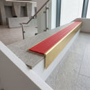 Solid brass stair nosing 59mm raked back slimline in satin brass finish with poppy castellated anti-slip insert, fitted to a stair tread