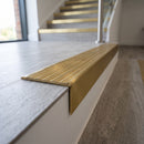 Solid brass stair nosing 59mm raked back slimline in satin brass finish with satin brass anti-slip insert, fitted to a stair tread