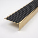 Solid brass stair nosing 59mm raked back slimline profile in satin brass finish with black castellated insert, studio view