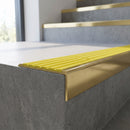 Solid Brass Stair Nosing 59mm Slimline Profile with Infill in polished brass finish fitted on a step edge