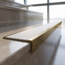 Solid Brass Stair Nosing 59mm Tread Raked Back Profile in antique brass finish fitted on a step edge