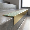 Solid Brass Stair Nosing 59mm Tread Raked Back Profile in satin brass finish fitted on a step edge