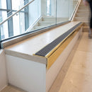 Solid brass stair nosing, 59.5mm tread with a 30mm raked-back front, in Polished Brass finish with Regency Castellated insert, fitted to a staircase
