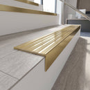 Solid brass stair nosing, 59.5mm tread with a 30mm raked-back front, in Satin Brass finish with Polished Brass insert, fitted to a staircase