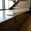 Solid Brass Stair Nosing 60mm Tread Raked Back Single Channel in antique brass finish fitted on a step edge