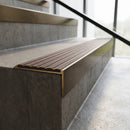 Solid Brass Stair Nosing 60mm Tread Raked Back Single Channel in antique bronze finish fitted on a step edge