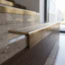 Solid Brass Stair Nosing 62.8mm Ribbed Tread Raked Edge in antique brass finish fitted on a step edge