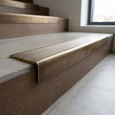 Solid Brass Stair Nosing 62.8mm Ribbed Tread Raked Edge in antique bronze finish fitted on a step edge