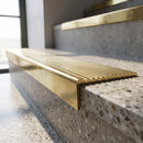 Solid Brass Stair Nosing 62.8mm Ribbed Tread Raked Edge in polished brass finish fitted on a step edge