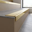 Solid Brass Stair Nosing 62.8mm Ribbed Tread Raked Edge in satin brass finish fitted on a step edge