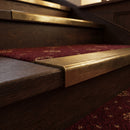 Solid brass stair nosing 62mm ribbed tread in antique brass finish fitted on a step edge