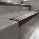 Solid brass stair nosing 62mm ribbed tread in antique bronze finish fitted on a step edge